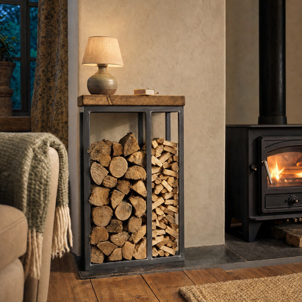 Langdale Log and Kindling Store in raw steel beside a wood burner