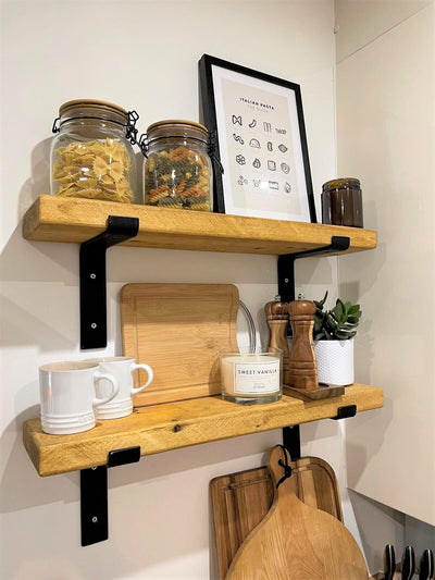 bright image of two shelves in a kitchen. Pasta jars and kitchen utensils held on shelf. 